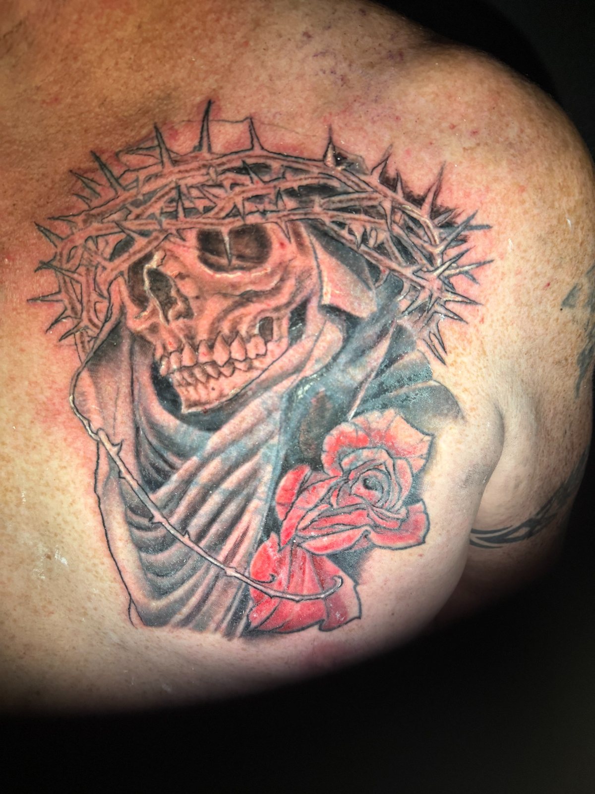Black and grey skull and rose corrective tattoo work by Joshua Cole