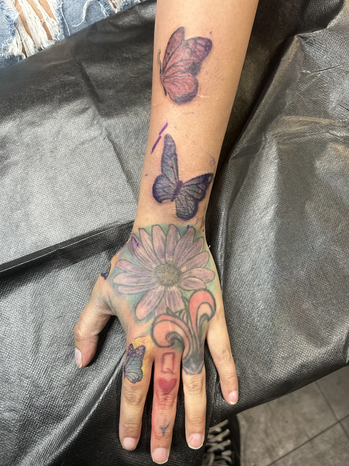 Consult photo — faded hand tattoos assessed for cover-up planning, Las Vegas