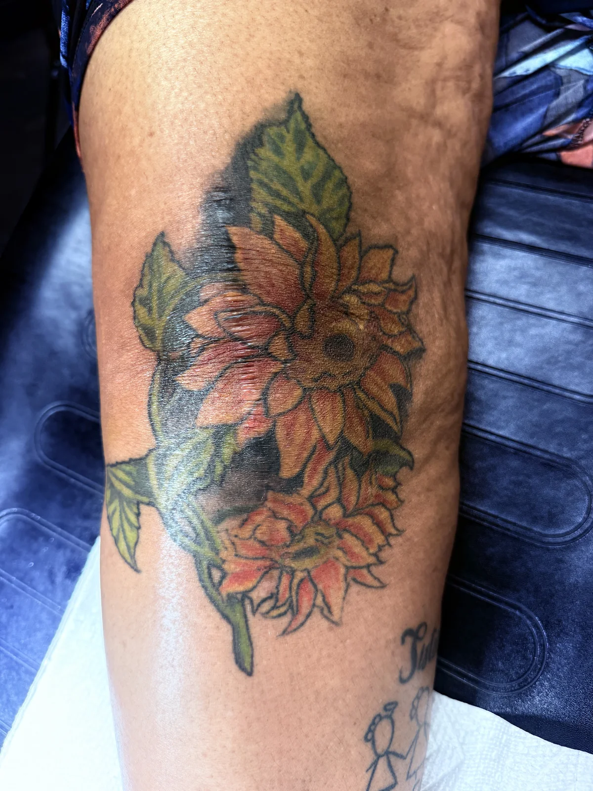 Leg tattoo cover up — sunflower over dense black ink, Work of Art Las Vegas