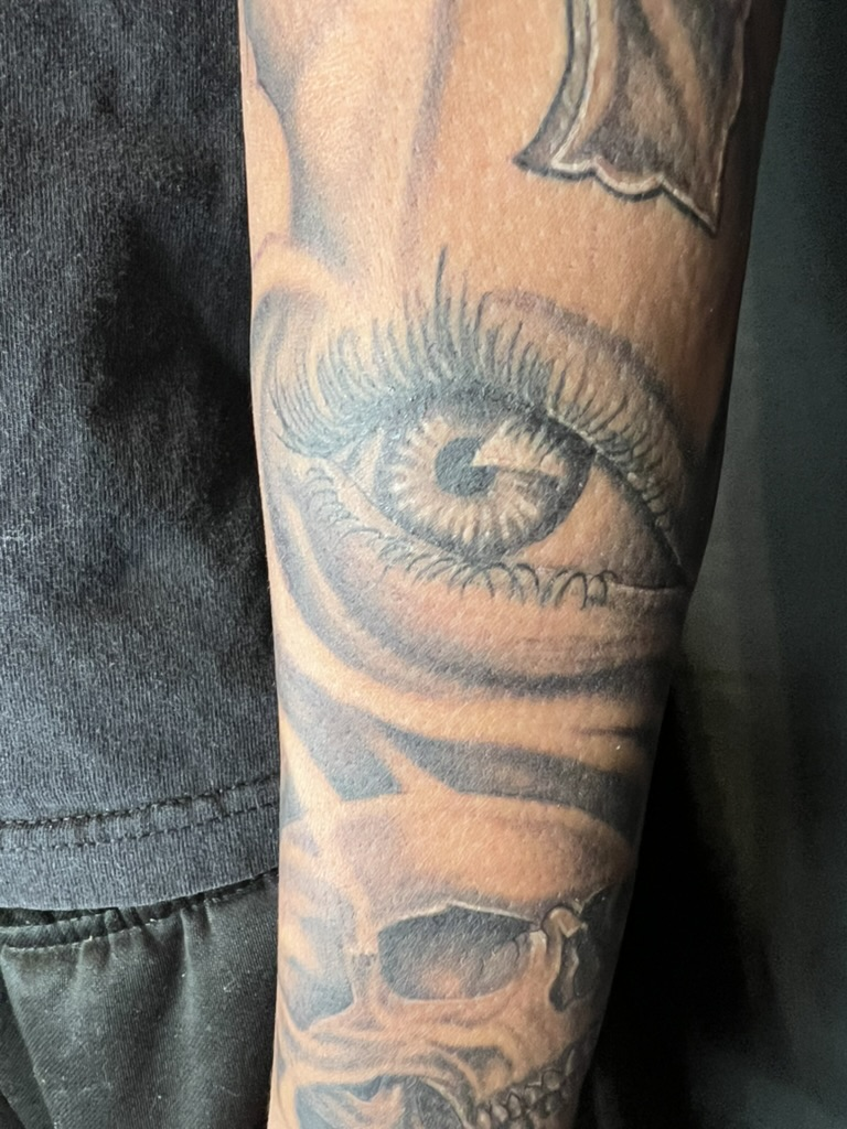 One-year healed cross eye skull forearm tattoo full length photo by Joshua Cole, Work of Art Las Vegas