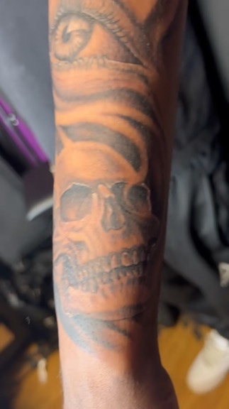 One-year healed skull and eye forearm close-up black and grey realism by Joshua Cole, Las Vegas