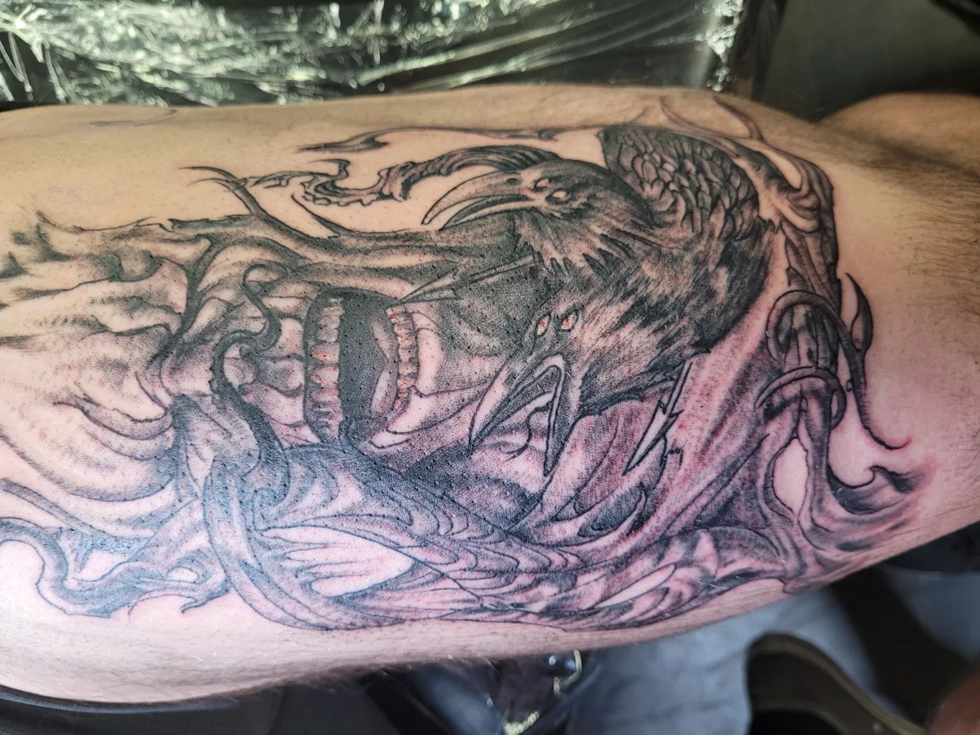 Black and grey dark realism tattoo of three-eyed ravens with teeth and smoke — Work of Art Tattoo Las Vegas