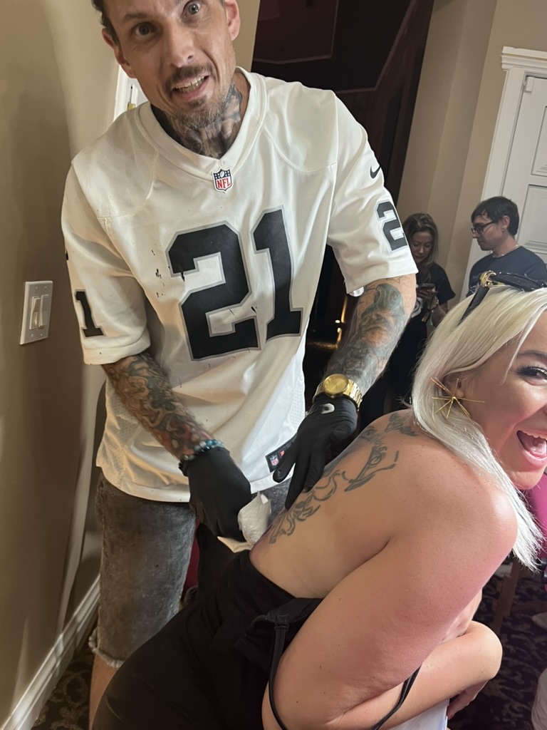 Joshua Cole wipes fresh phoenix back tattoo as laughing blonde client reacts offsite — Joshua Cole offsite booking, Work of Art Las Vegas