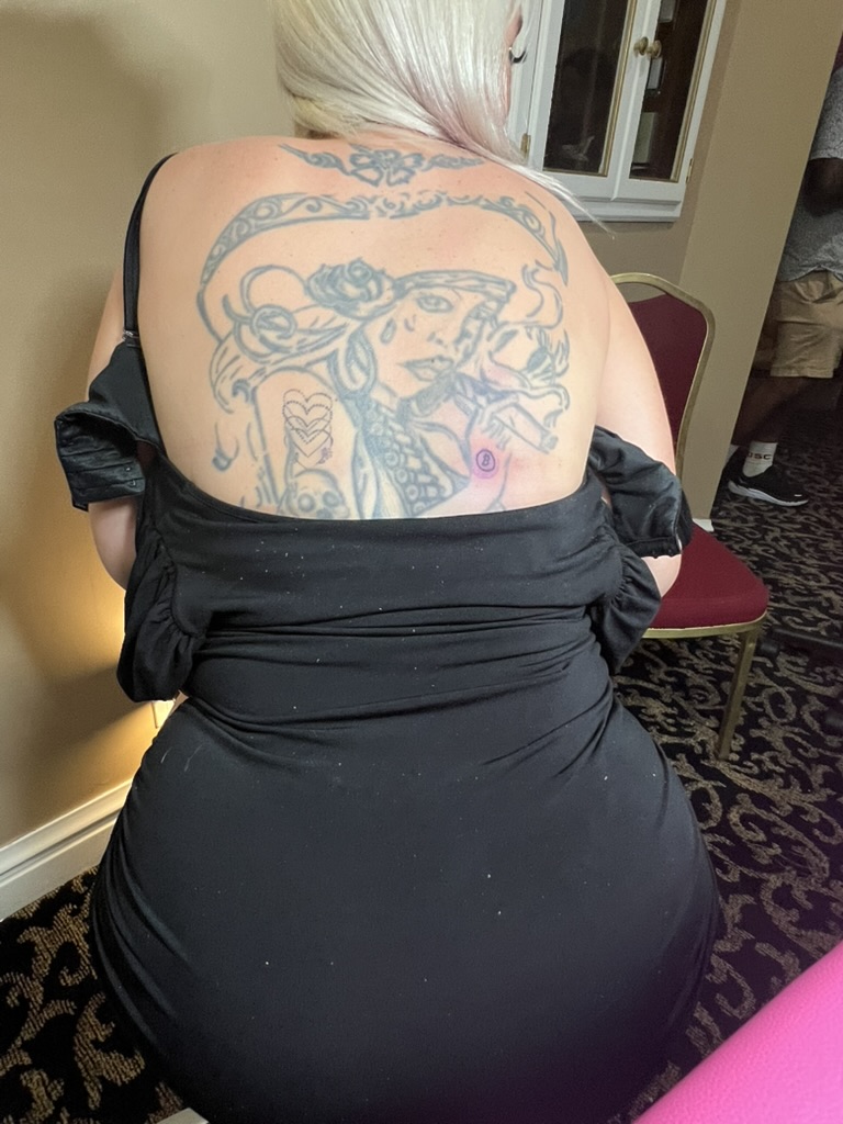 Fresh Bitcoin logo tattoo on shoulder beside faded black-grey back piece offsite — Joshua Cole offsite booking, Work of Art Las Vegas