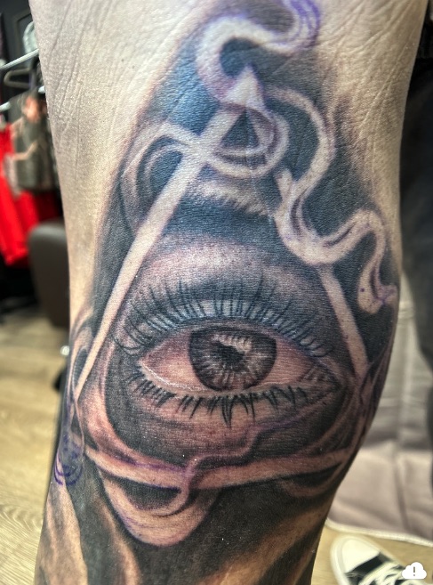 Black and grey all-seeing eye in triangle with smoke ribbons — Joshua Cole, Work of Art Las Vegas