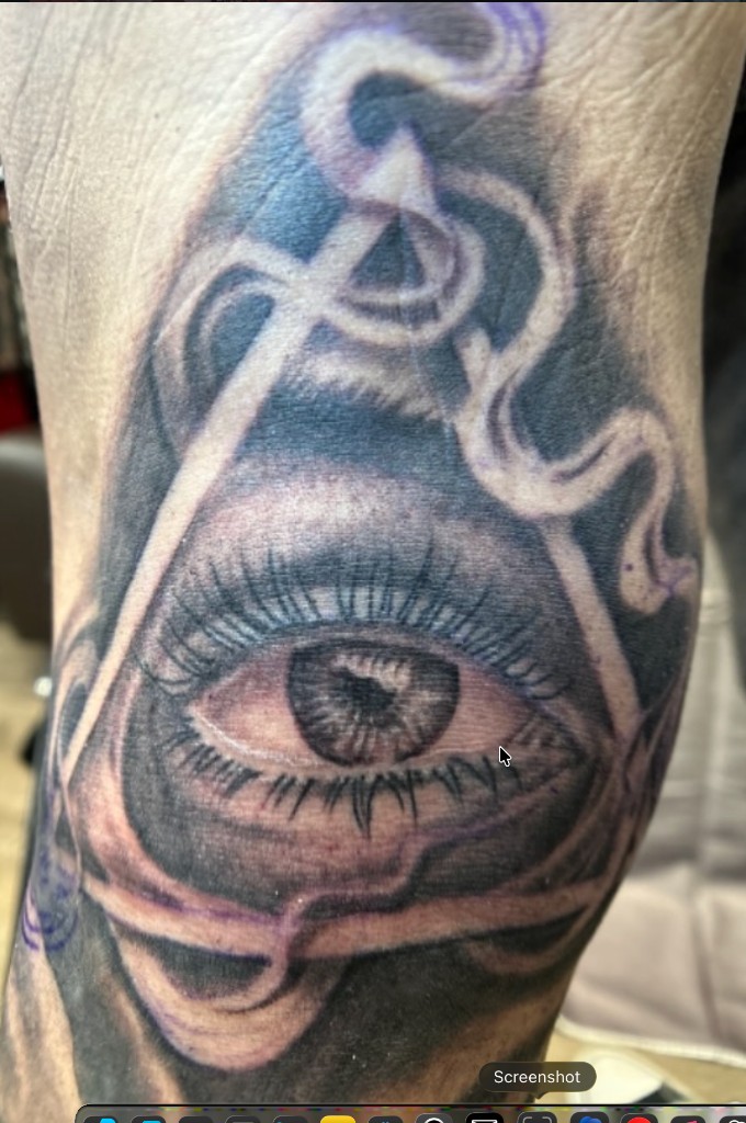 Realistic eye inside a triangle with swirling smoke ribbons, black-grey forearm piece — Joshua Cole, Work of Art Las Vegas