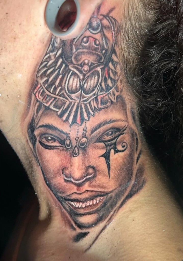 Black-grey Egyptian woman with scarab headdress and Eye of Horus mark on neck — Joshua Cole, Work of Art Las Vegas