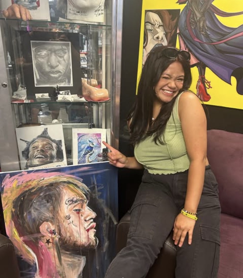 Guest admiring framed portrait art in the Work of Art studio gallery. — Joshua Cole, Work of Art Las Vegas