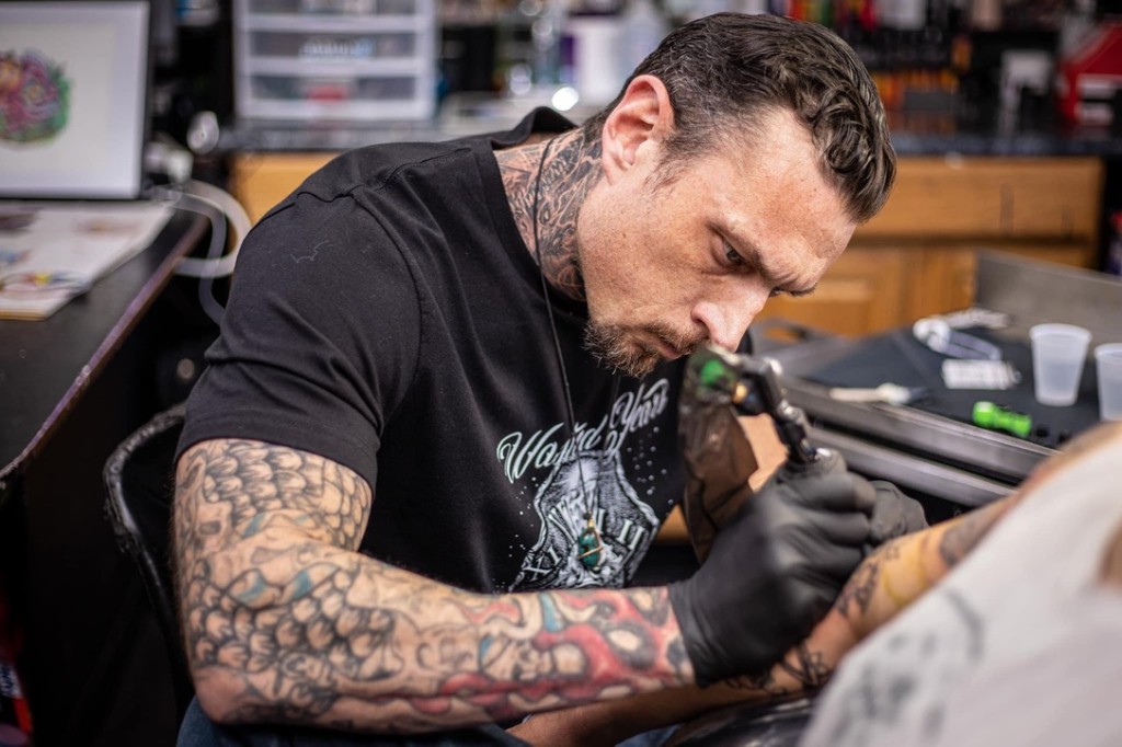 Joshua Cole tattooing a client's forearm with focused detail in the studio. — Joshua Cole, Work of Art Las Vegas