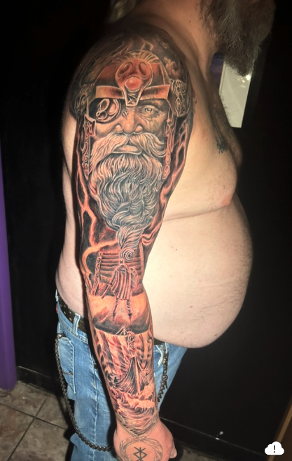 Full Norse sleeve — Odin portrait, longship, and runes with orange highlights — Joshua Cole, Work of Art Las Vegas