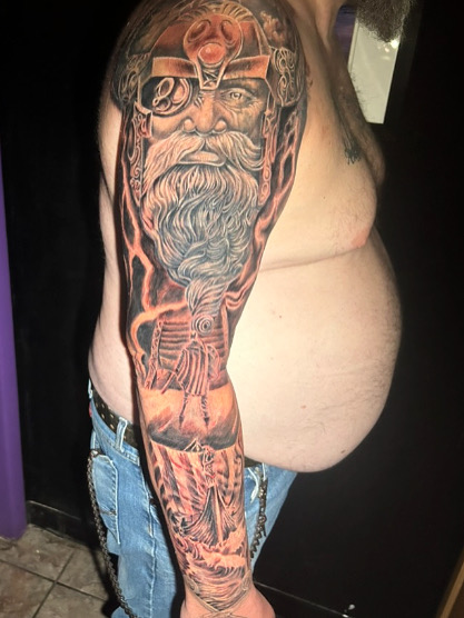 Norse Odin half sleeve with orange lightning — black and grey realism by Joshua Cole, Work of Art Las Vegas