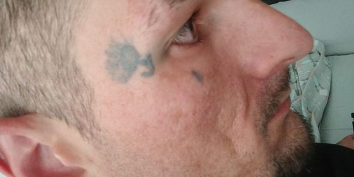 Side profile showing small fine-line temple and cheek tattoos on a man's face. — Joshua Cole, Work of Art Las Vegas