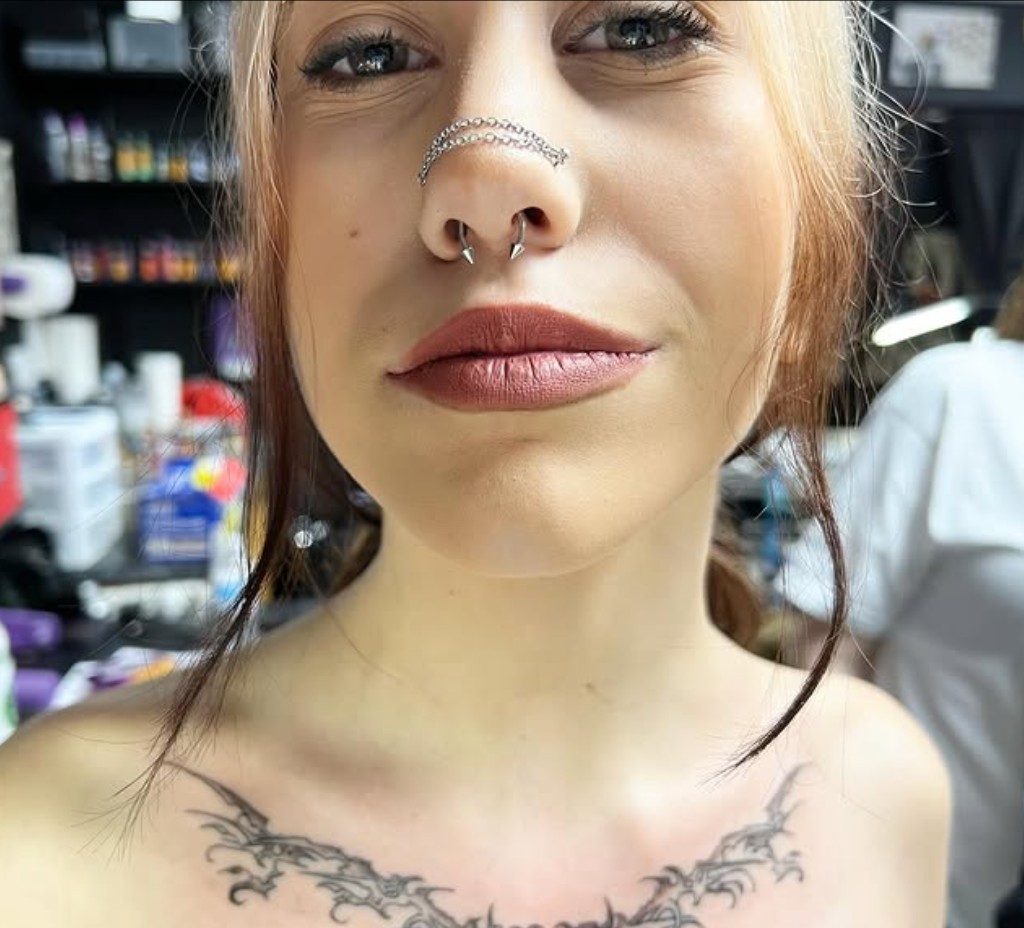 Spiked septum horseshoe with nose chain and symmetrical black chest filigree tattoo — Joshua Cole, Work of Art Las Vegas