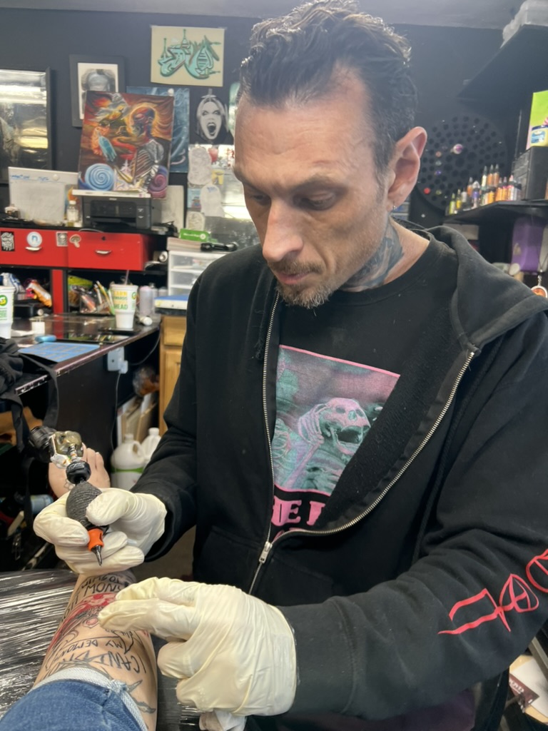 Joshua Cole at work on custom illustrative tattoo — Work of Art Las Vegas