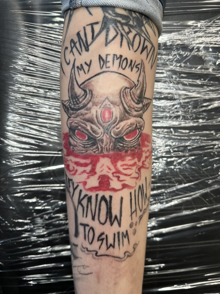 Illustrative three-eyed demon with lyric text — black, grey, and red by Joshua Cole, Work of Art Las Vegas