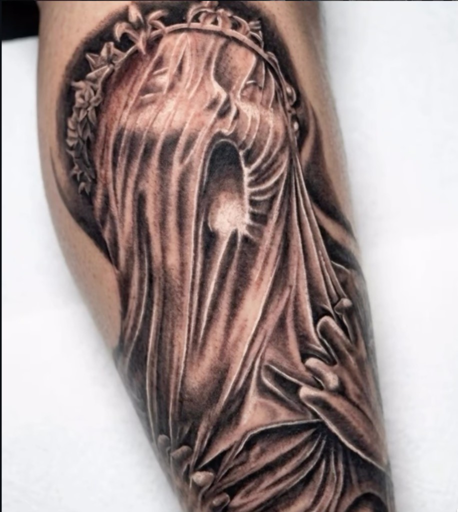 Black-grey veiled woman with ornate crown and clasped praying hands on forearm — Joshua Cole, Work of Art Las Vegas